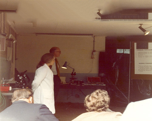 1977 Wallace Deas assisted by technician, Anne Williamson, explains the laboratory techniques used in fertility testing of farm animals